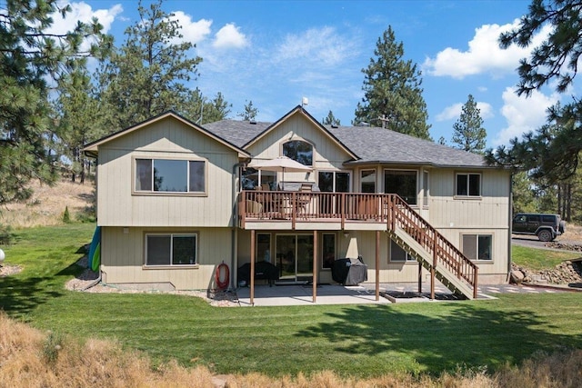 rear view of property with a lawn, a deck, and a patio