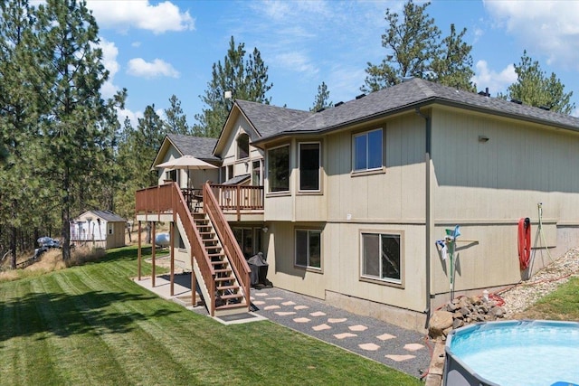 back of house featuring a lawn and a wooden deck