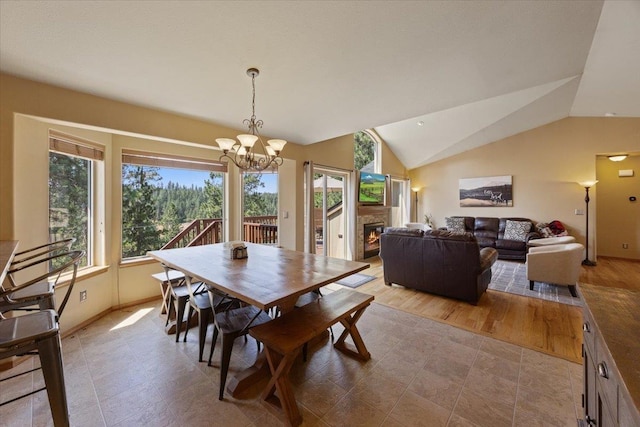 dining area featuring light hardwood / wood-style floors, a notable chandelier, a healthy amount of sunlight, and lofted ceiling