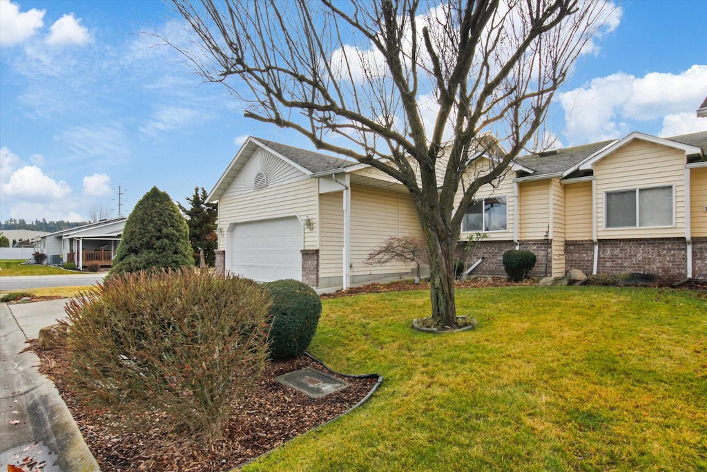 view of home's exterior with a lawn and a garage