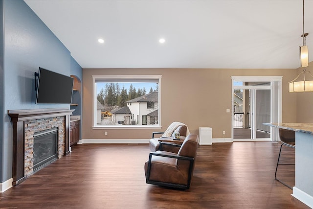 sitting room featuring a fireplace, dark hardwood / wood-style flooring, and lofted ceiling