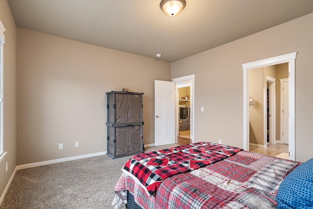 carpeted bedroom featuring washer / dryer