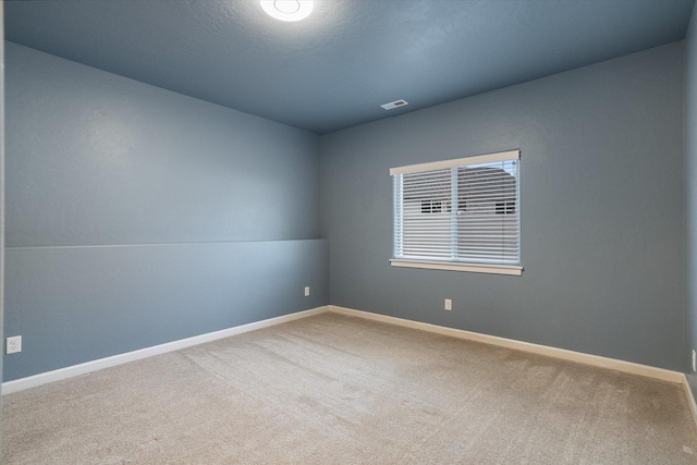 spare room with carpet flooring and a textured ceiling