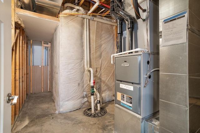 utility room featuring heating unit