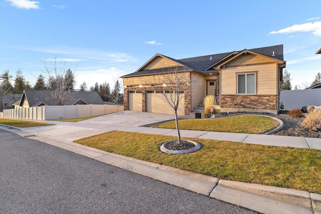 view of front of home with a garage and a front lawn