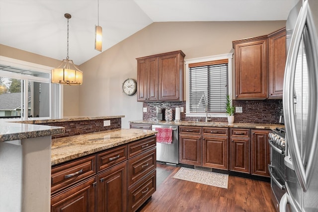 kitchen featuring appliances with stainless steel finishes, dark hardwood / wood-style flooring, tasteful backsplash, decorative light fixtures, and lofted ceiling