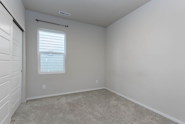 spare room with light colored carpet