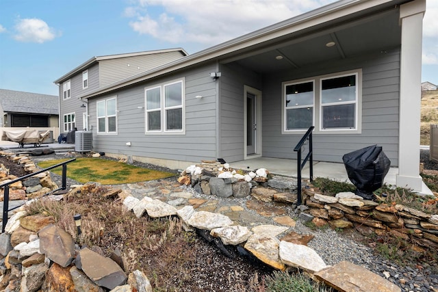 back of house featuring cooling unit and a patio