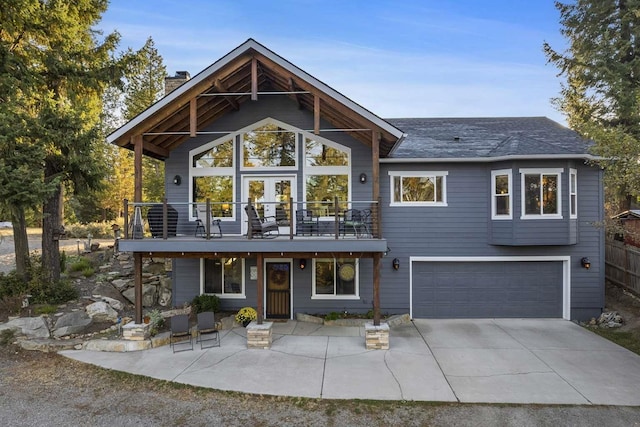 12507 N Cherokee Dr, Newman Lake, WA 99025 - view of front facade featuring a garage, a chimney, driveway, and a balcony