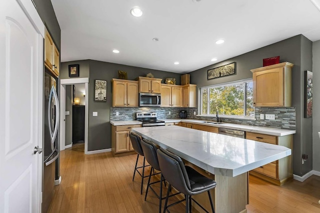 12507 N Cherokee Dr, Newman Lake, WA 99025 - kitchen with stainless steel appliances, a sink, backsplash, a kitchen bar, and recessed lighting