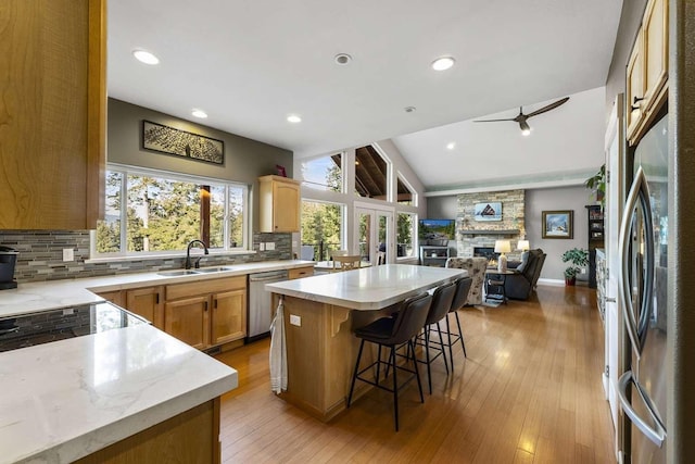 12507 N Cherokee Dr, Newman Lake, WA 99025 - kitchen featuring appliances with stainless steel finishes, a sink, tasteful backsplash, a ceiling fan, and a center island
