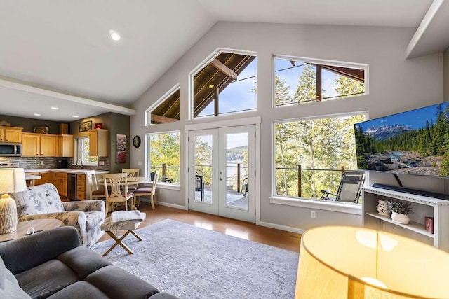 12507 N Cherokee Dr, Newman Lake, WA 99025 - living room with healthy amount of natural light, high vaulted ceiling, baseboards, light wood-type flooring, and recessed lighting