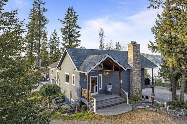 12507 N Cherokee Dr, Newman Lake, WA 99025 - chalet / cabin featuring roof with shingles and a chimney