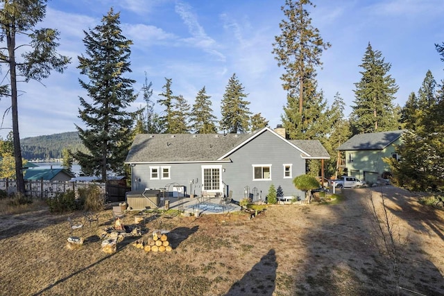 12507 N Cherokee Dr, Newman Lake, WA 99025 - rear view of property with a chimney, fence, a wooden deck, and roof with shingles