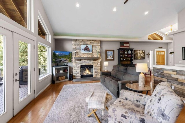 12507 N Cherokee Dr, Newman Lake, WA 99025 - living area with a ceiling fan, plenty of natural light, a fireplace, high vaulted ceiling, and wood-type flooring