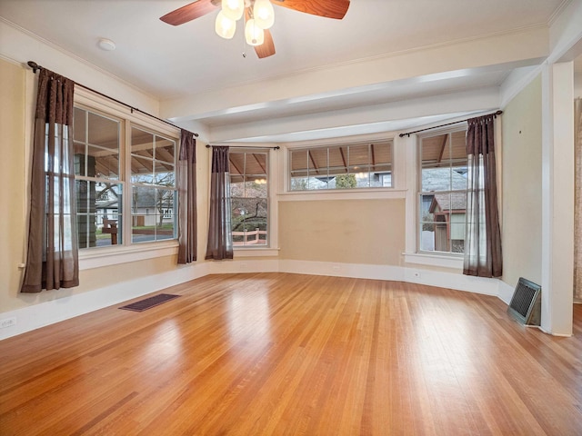 unfurnished room with light wood-type flooring, ceiling fan, and crown molding