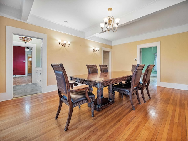 dining space featuring beam ceiling, light wood-type flooring, and a notable chandelier