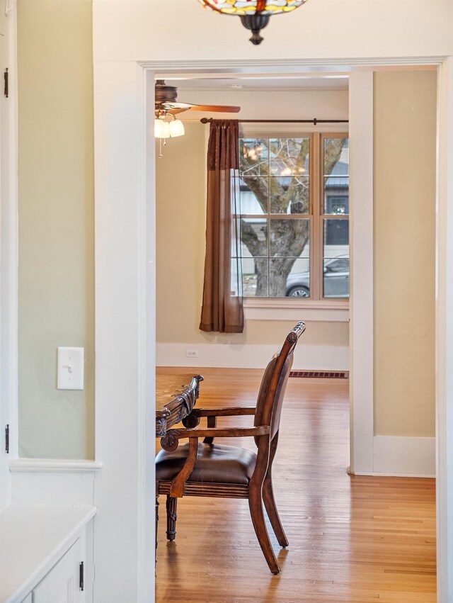 dining room with ceiling fan and light hardwood / wood-style floors