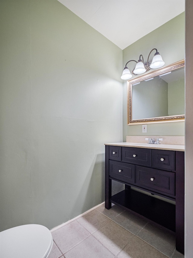 bathroom featuring tile patterned floors, vanity, and toilet