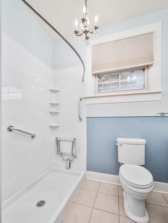 bathroom featuring tile patterned flooring, a chandelier, and toilet