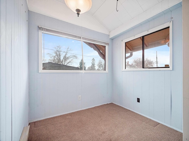 unfurnished room featuring carpet and lofted ceiling