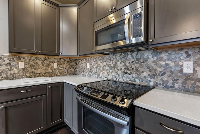 kitchen with backsplash and appliances with stainless steel finishes