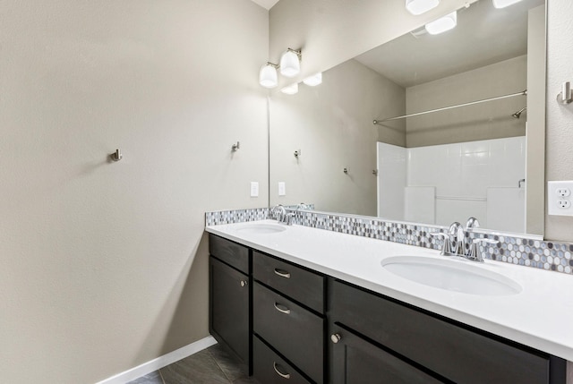 bathroom with vanity, tile patterned floors, and backsplash