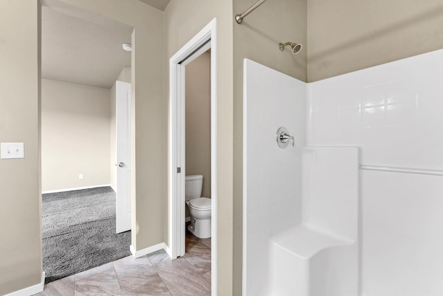 bathroom with a shower and toilet