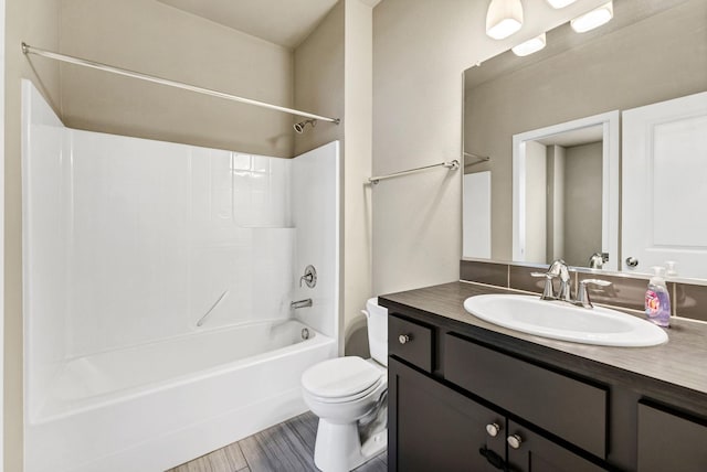 full bathroom featuring vanity, bathtub / shower combination, and toilet