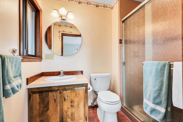 bathroom with tile patterned floors, vanity, toilet, and an enclosed shower