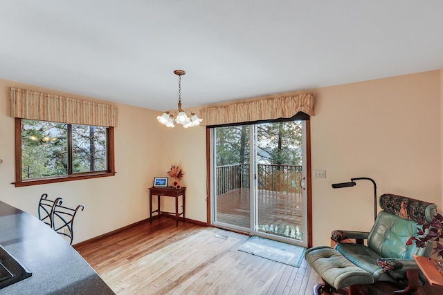 interior space with light hardwood / wood-style flooring and an inviting chandelier