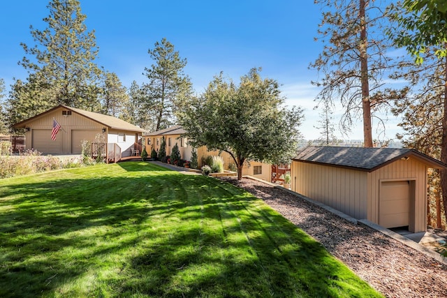 view of yard with an outbuilding and a garage