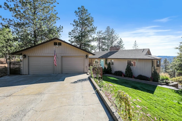 single story home featuring a garage and a front yard