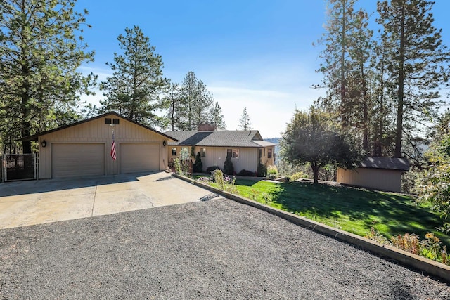 single story home featuring a front lawn, a shed, and a garage