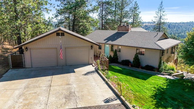 single story home featuring a garage and a front lawn