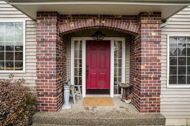 property entrance featuring brick siding