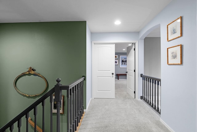 hallway with light colored carpet