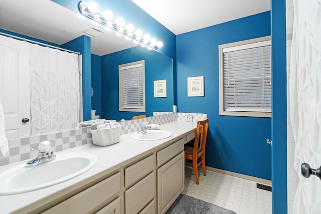 bathroom with vanity and backsplash