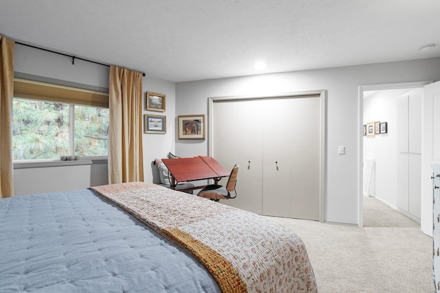 bedroom featuring light carpet and a closet