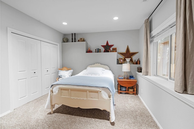 bedroom with carpet and a closet