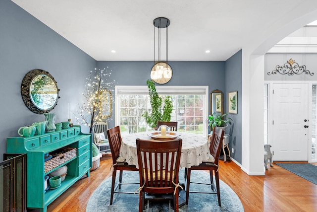 dining space featuring light hardwood / wood-style flooring and a notable chandelier