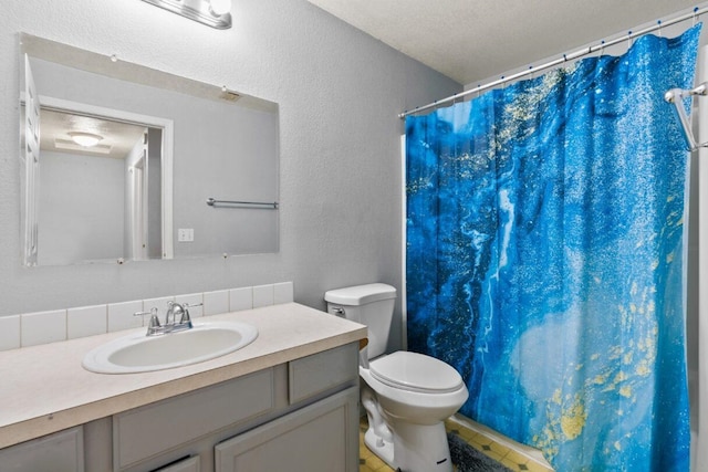 bathroom with vanity, a textured ceiling, toilet, and walk in shower