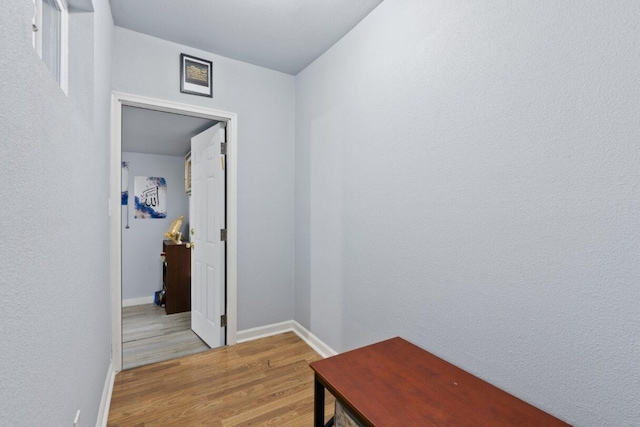 corridor with light hardwood / wood-style floors