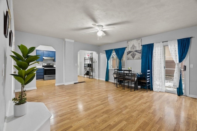 interior space with ceiling fan, a textured ceiling, and light hardwood / wood-style flooring