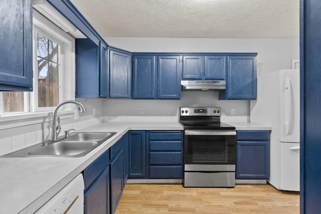 kitchen featuring a textured ceiling, white appliances, sink, and blue cabinets