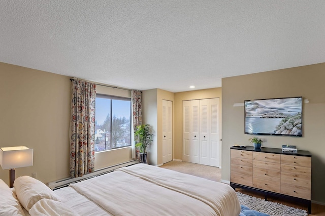 bedroom with a textured ceiling and baseboard heating