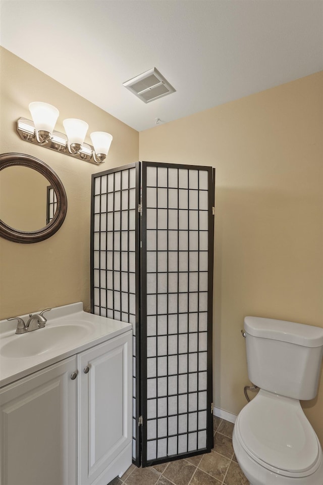 bathroom featuring tile patterned floors, vanity, and toilet