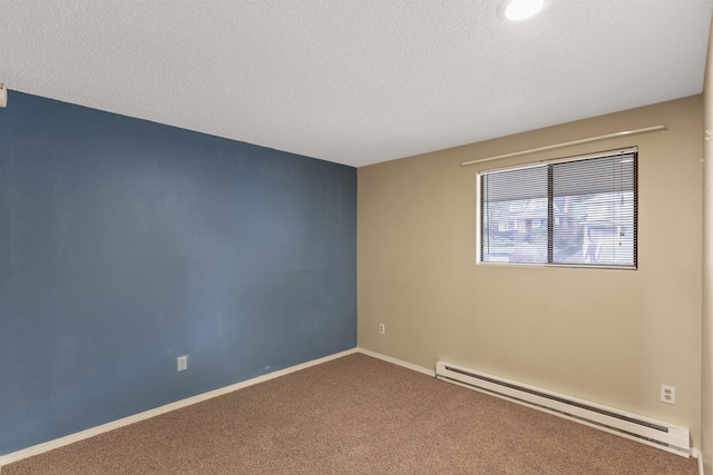 empty room featuring carpet, baseboard heating, and a textured ceiling