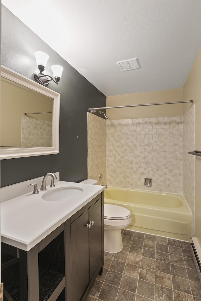 full bathroom featuring toilet, vanity, and tiled shower / bath