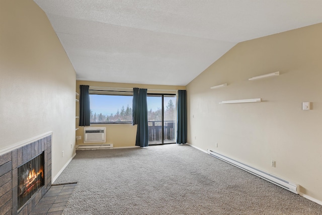 unfurnished living room featuring a baseboard radiator, a wall unit AC, carpet floors, vaulted ceiling, and a fireplace